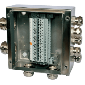 An open metallic electrical junction box with multiple cable glands and a terminal block inside